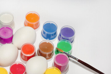 Staining fresh white eggs before Easter. Holiday preparation concept
