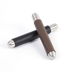 Black and brown leather cigar holders on a white background