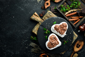 Pavlov's dessert. Bizet cakes with chocolate. Sweets. Top view. Rustic style.