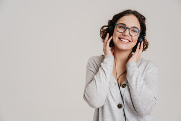 Lovely young woman listening to music with headphones