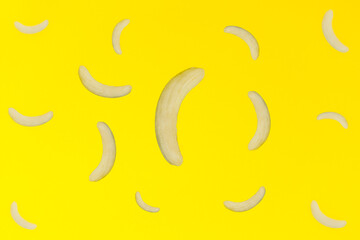 pattern of peeled bananas falling in the air isolated on a bright yellow background. Food levitation concept.