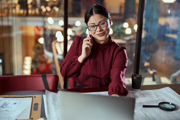 Sincere Asian woman working at her project