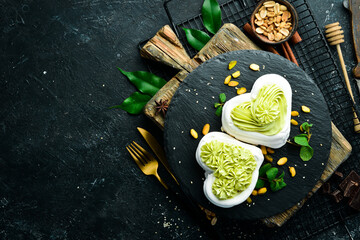 Pavlov's dessert. Bizet cakes with pistachio cream. Sweets. Top view. Rustic style.