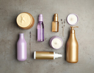 Flat lay composition with hair care cosmetic products on grey stone table