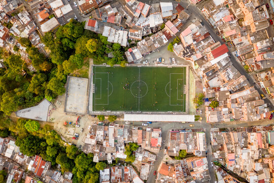 Aerial view of a small football stadium in a high dented population residential district in Medellin, Antioquia, Colombia.