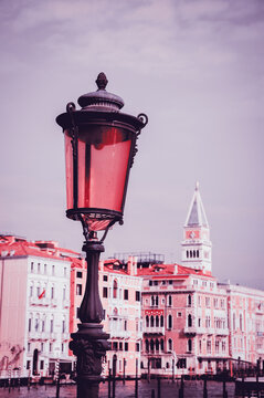 Romantic Venice. Vintage pohoto of Venetian streetlight and Grand canal palaces with bell tower of St Mark's Basilica at background. Venice, Italy. 