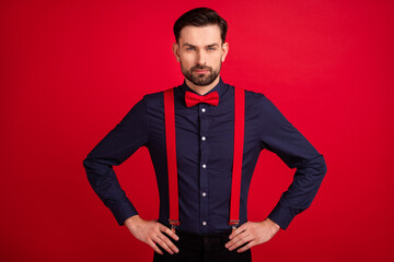 Photo of young handsome serious businessman boss unhappy with problems at work isolated on red color background