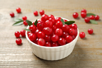 Tasty ripe cranberries on wooden table, closeup