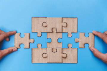  Hand of woman connecting jigsaw puzzle, Business solutions, success and strategy, Business partnership concept.