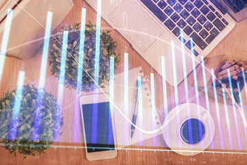 Multi exposure of financial chart hologram over desktop with phone. Top view. Mobile trade platform...