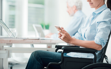 Businesswoman in wheelchair using a smart phone