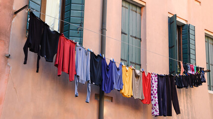 Clean clothes hanging to dry outdoor of old house. Venice, Italy.