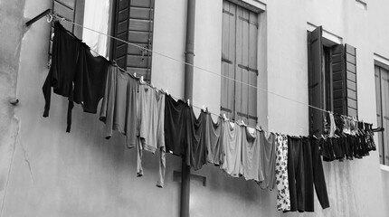 Clean clothes hanging to dry outdoor of old house. Venice, Italy. Black white historic photo.