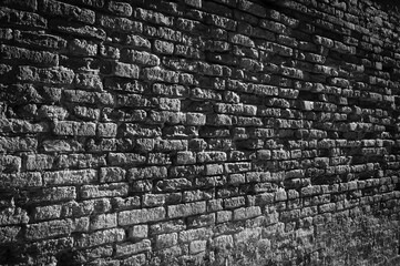 Old brick wall perspective background. Venice, Italy. Black white historic photo
