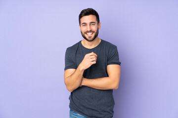 Caucasian handsome man laughing over isolated purple background