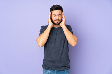 Fototapeta premium Caucasian handsome man with headache over isolated purple background