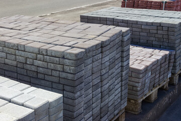 Concrete pavement tiles stacked on the pallets on outdoor warehouse