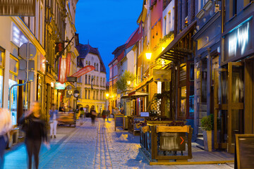 Fototapeta na wymiar Night view of Torun streets and building illuminated at dusk, old town in Poland