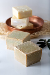 Olive oil based hand-cut soap on white background.