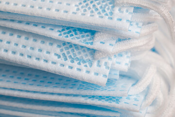 Textured surface of polyester fiber medical masks with side ties closeup