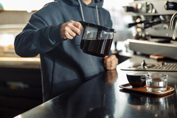 Happy smiling professional barista in cafe