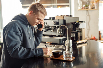 Happy smiling professional barista in cafe