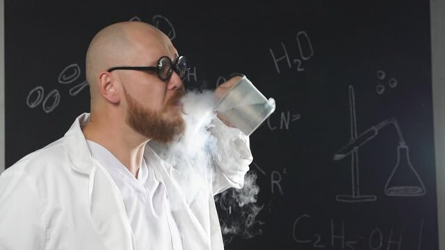 Portrait of a mad chemical scientist drinking liquid nitrogen and exhaling white smoke from his mouth, slow motion.
