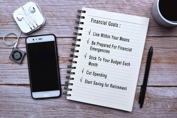 Financial goals text on wooden desk with accessories
