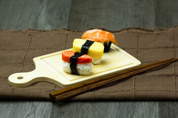 Sushi Set sashimi and sushi rolls served on wood background