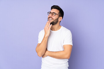 Caucasian handsome man over isolated background looking up while smiling