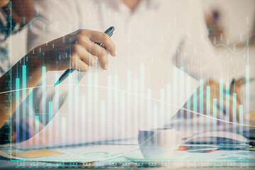 Double exposure of forex graph drawing over people taking notes background. Concept of financial analysis