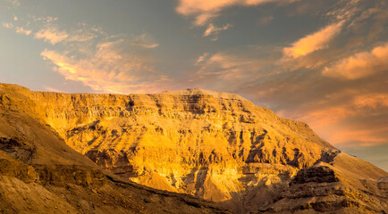 Panorama of stony slopes of the mountains against the sky.