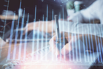 Double exposure of forex chart drawing over people taking notes background. Concept of financial...