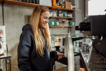 Fototapeta na wymiar Happy smiling professional barista in cafe