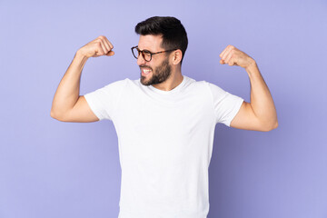 Fototapeta premium Caucasian handsome man over isolated background doing strong gesture