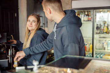 Happy smiling professional barista in cafe
