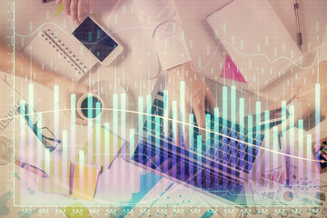 Multi exposure of man's hands typing over computer keyboard and forex graph hologram drawing. Top view. Financial markets concept.