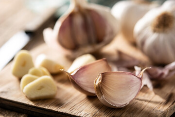 Garlic cloves on rustic wooden table. Close up