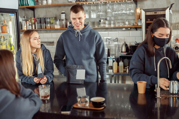 Happy smiling professional barista in cafe