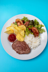 fried ground meat with tomato sauce, rice and potato chips on dish