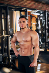 Fototapeta na wymiar Handsome young bodybuilder spending day in gym