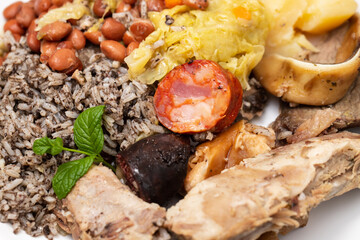 typical portuguese dish boiled meat, smoked sausages and vegetables on white dish