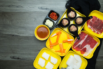 fresh raw pork, meat ,beef, belly,crab stick sliced on square plate  on wood, wooden background,set shabu, hot pot ingredients.