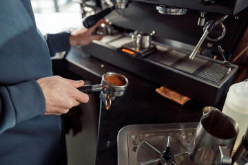 Happy smiling professional barista in cafe
