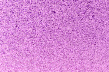 The surface of the textured fabric is purple-pink as a background, texture, pattern.