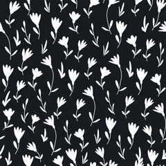 Seamless pattern of small flowers on black background. Floral print