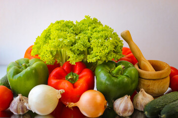 Prepare for a wonderful vegetarian lunch. Washed bell peppers, onions, garlic and lettuce leaves