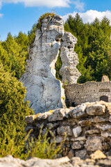 Limestone rocks surrounding medieval Ogrodzieniec Castle, part of Eagles’ Nests Trail at Cracow-Czestochowa upland in Podzamcze of Silesia region of Poland - obrazy, fototapety, plakaty