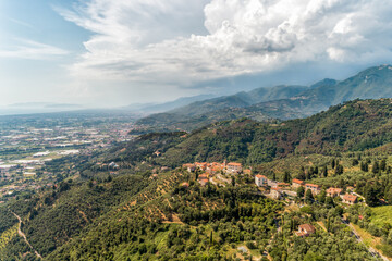Obraz premium Aerial view of the Tuscan village Mommio Castello, at the top of the hill of Versilia, province of Lucca, Italy