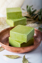 Organic natural handmade bay laurel soap with olive oil and leaves on white background.  Traditional daphne soap. 